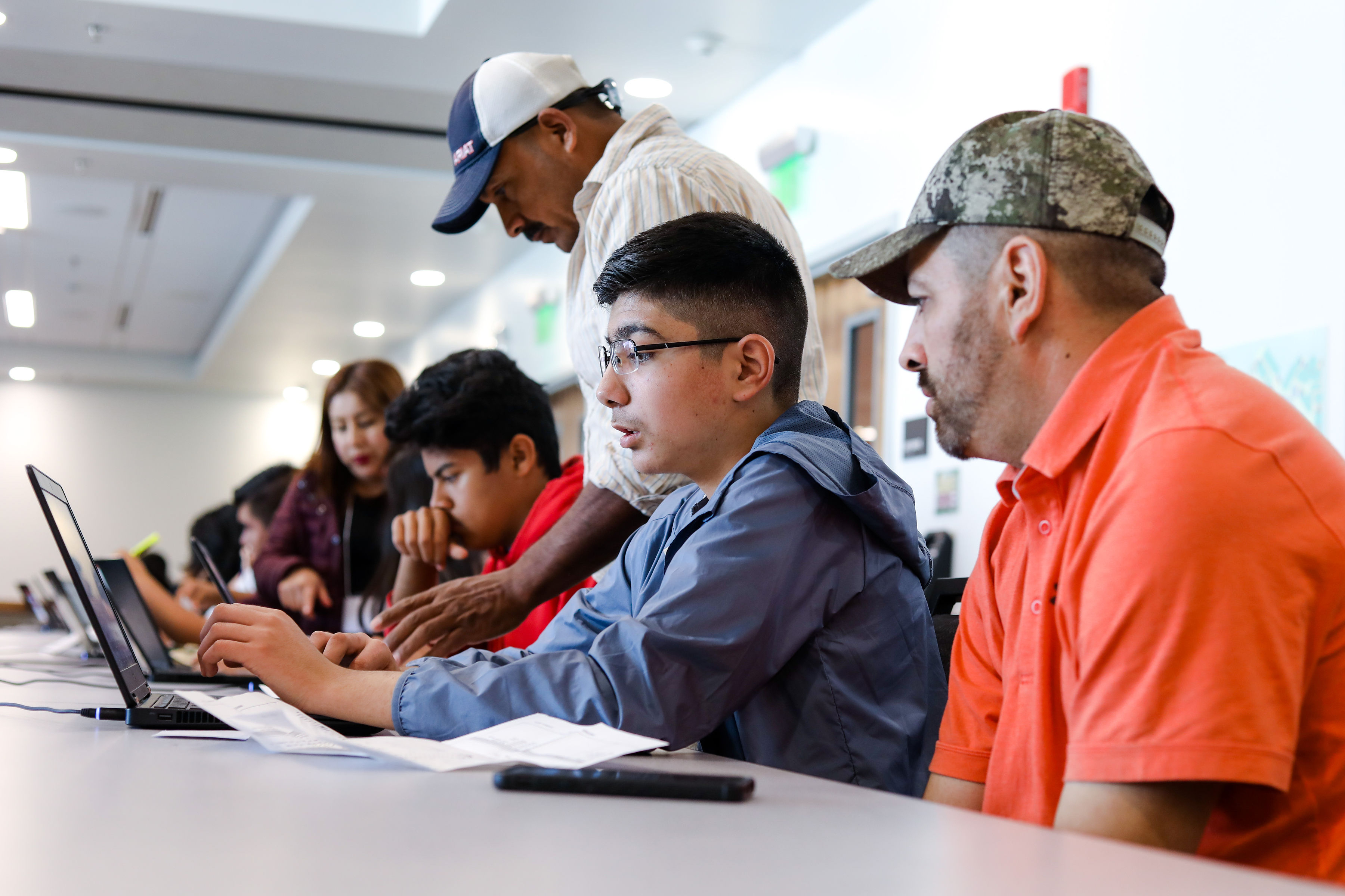 Participants in the 2019 Feria de Educación fair work on a laptop to access resources for navigating the California education system.