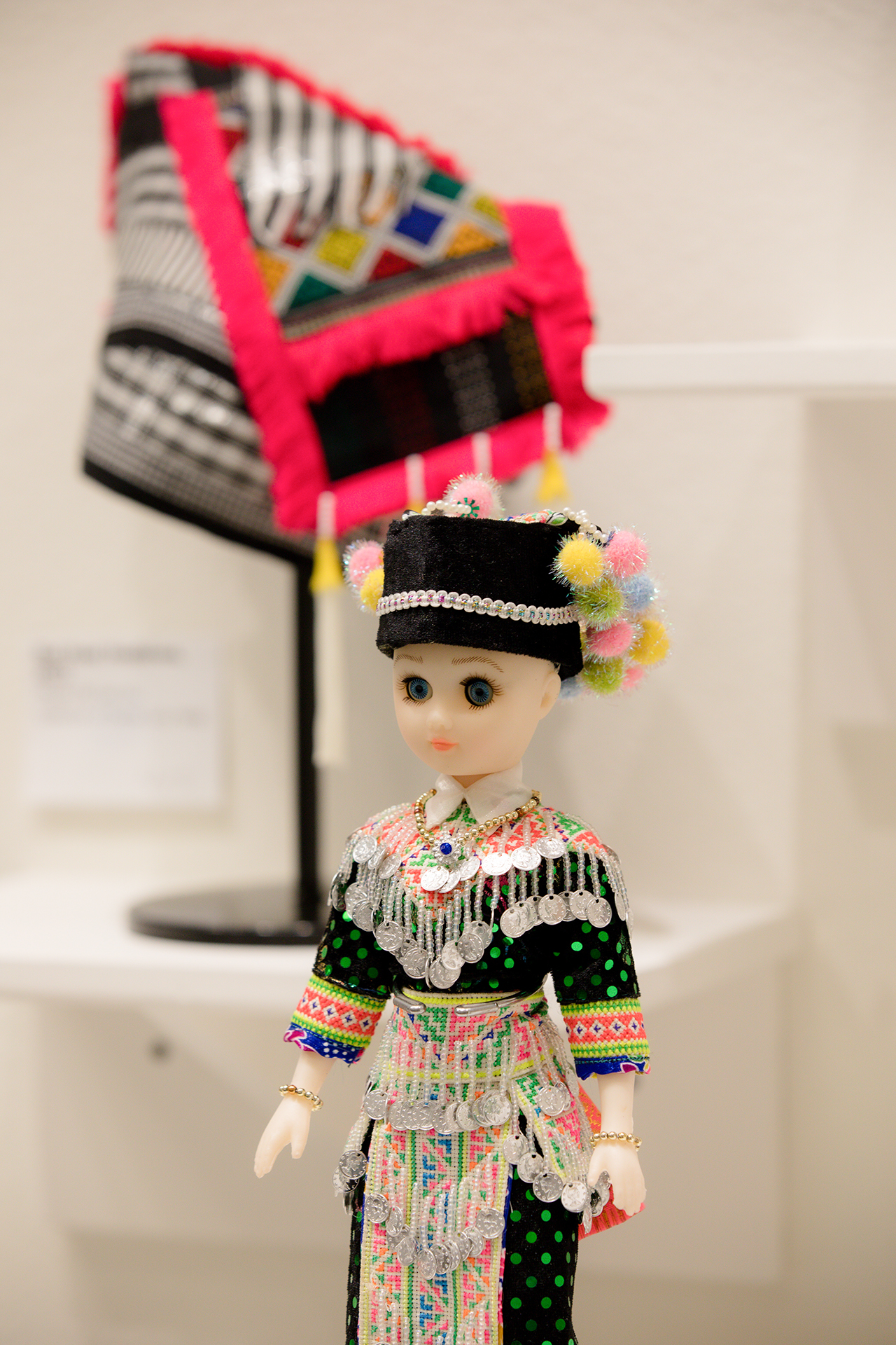 A doll on display as part of the Cloth as Community exhibit is dressed in traditional Hmong clothing.