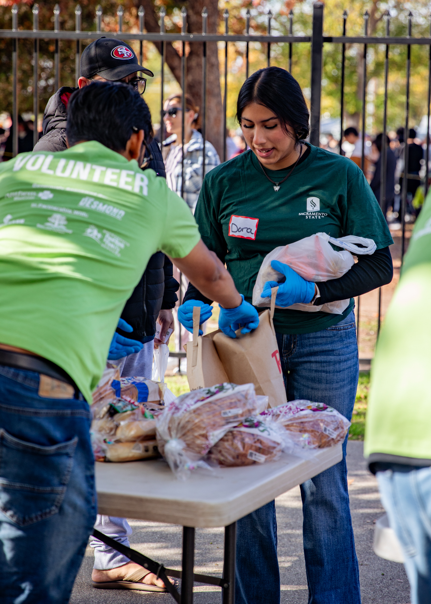 Volunteers pack items for those experiencing food insecurity during a recent food distribution event.
