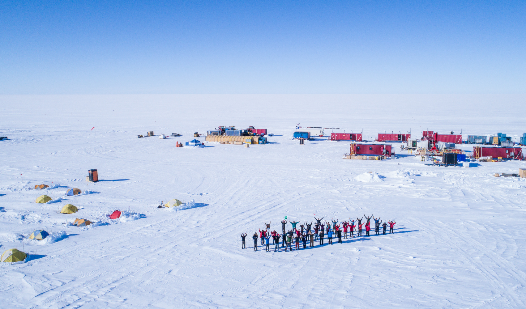 A group of researchers stationed in Antarctica with tents and equipment during the filming of a documentary. 