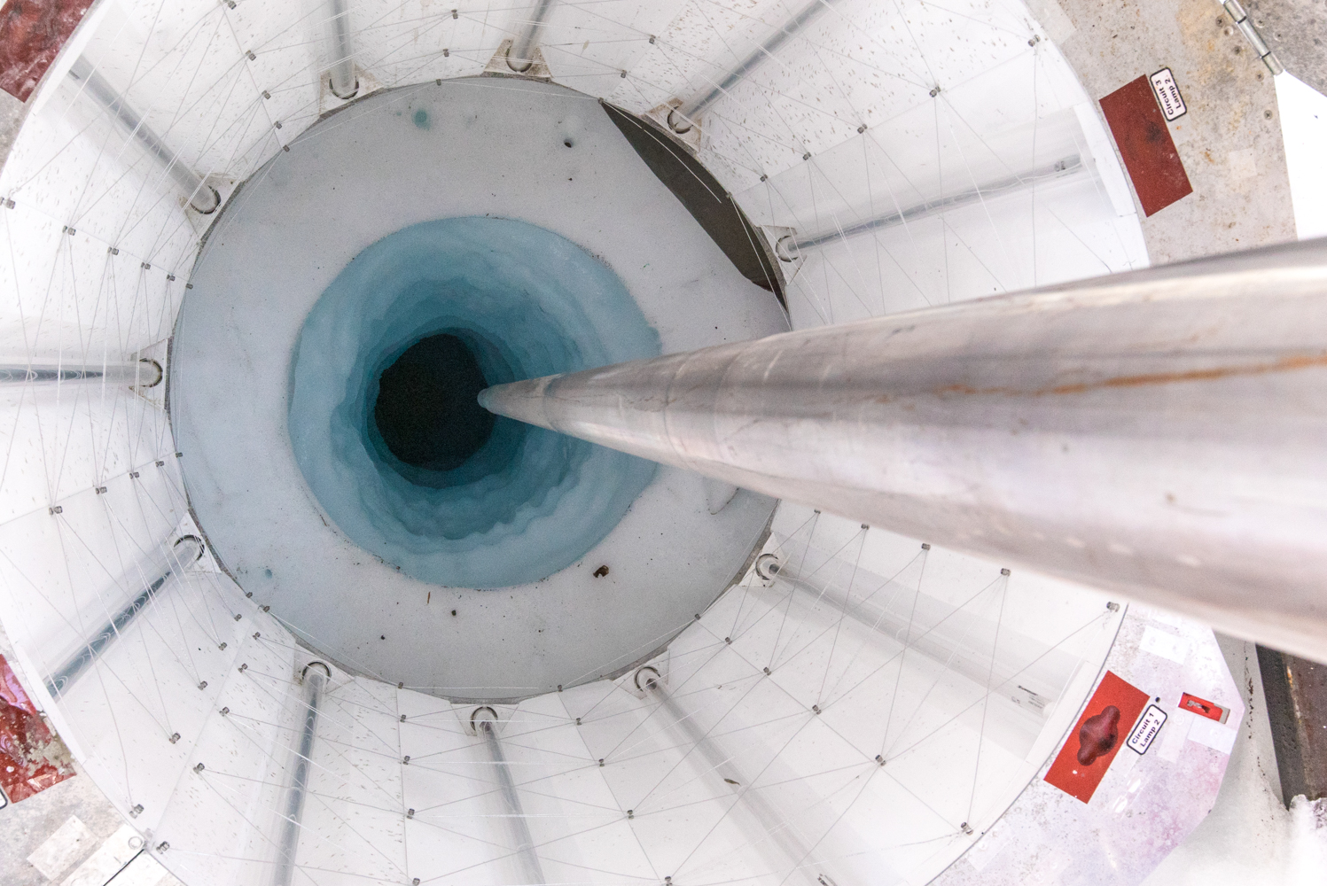 A hot water drill punctured holes thousands of feet deep into ice to collect samples.