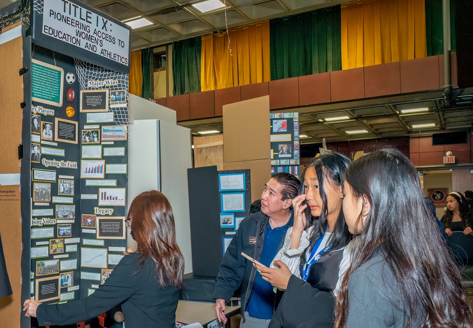 A group observes one of the National History Day projects on the history of Title IX.