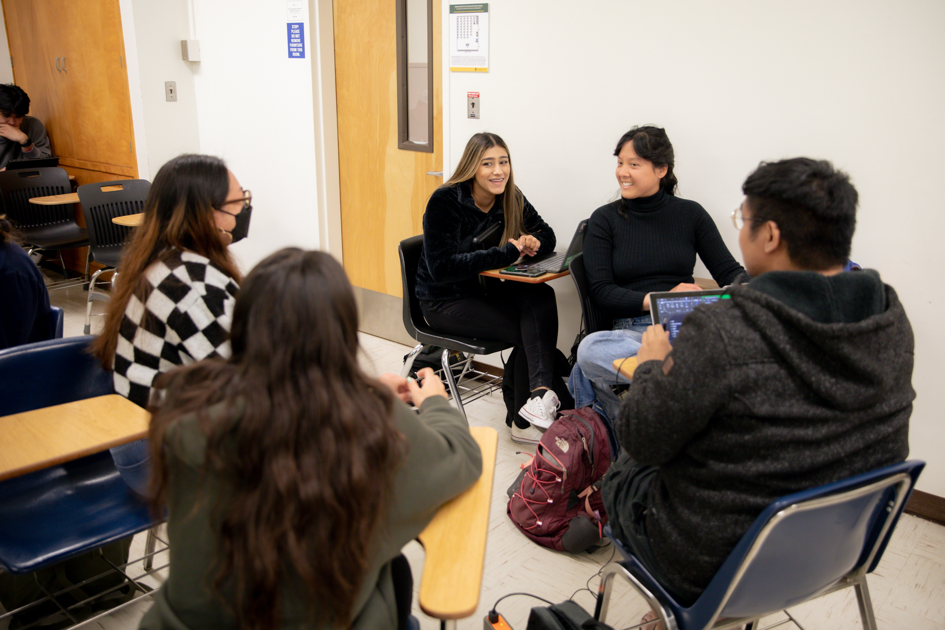 A group of students discuss a class project.