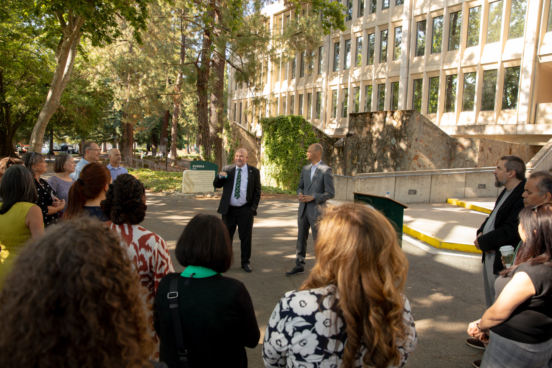 A small gathering to celebrate funding for a new early childhood education innovation center.