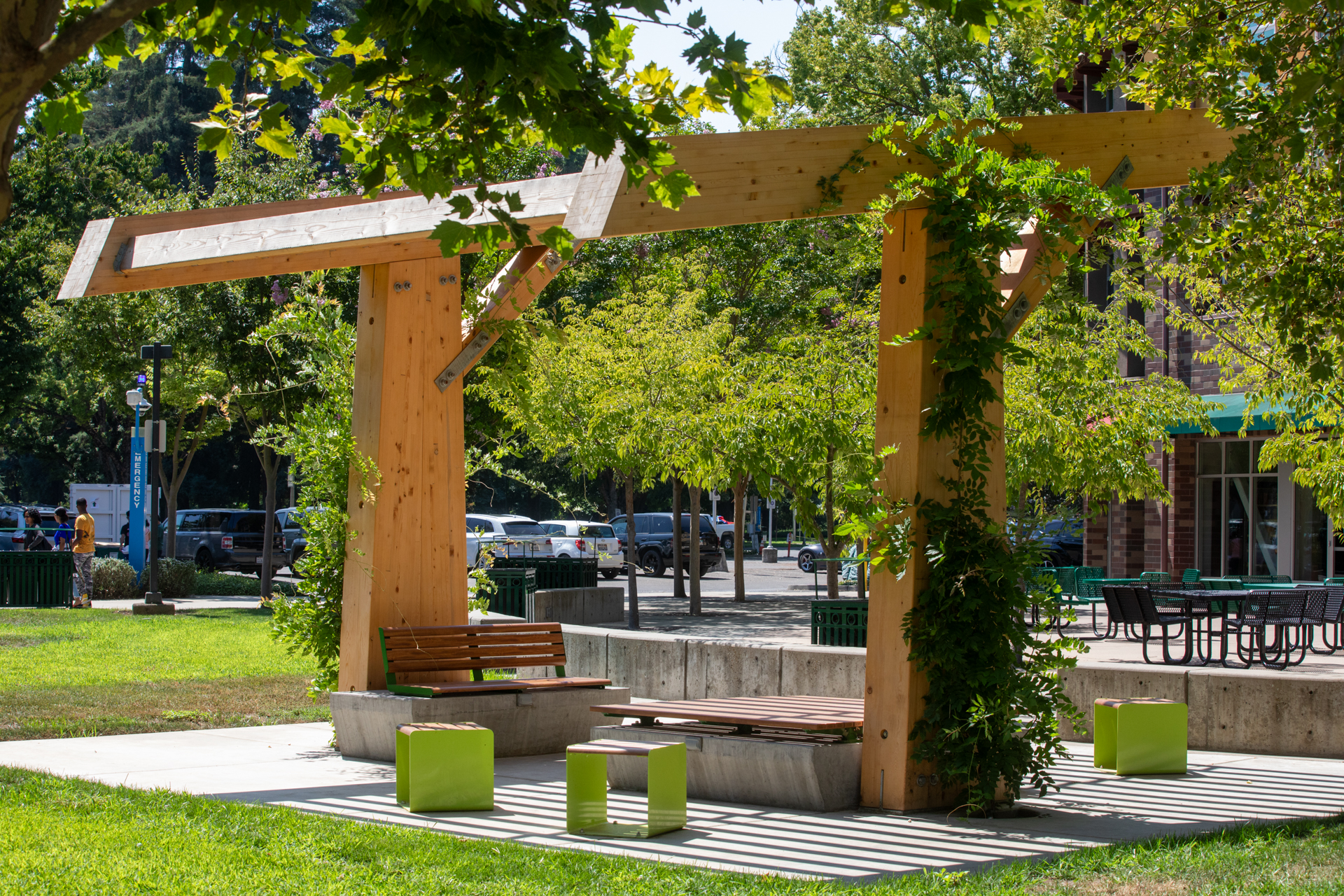 One of eight new pergolas on campus provides seating and shade for students.