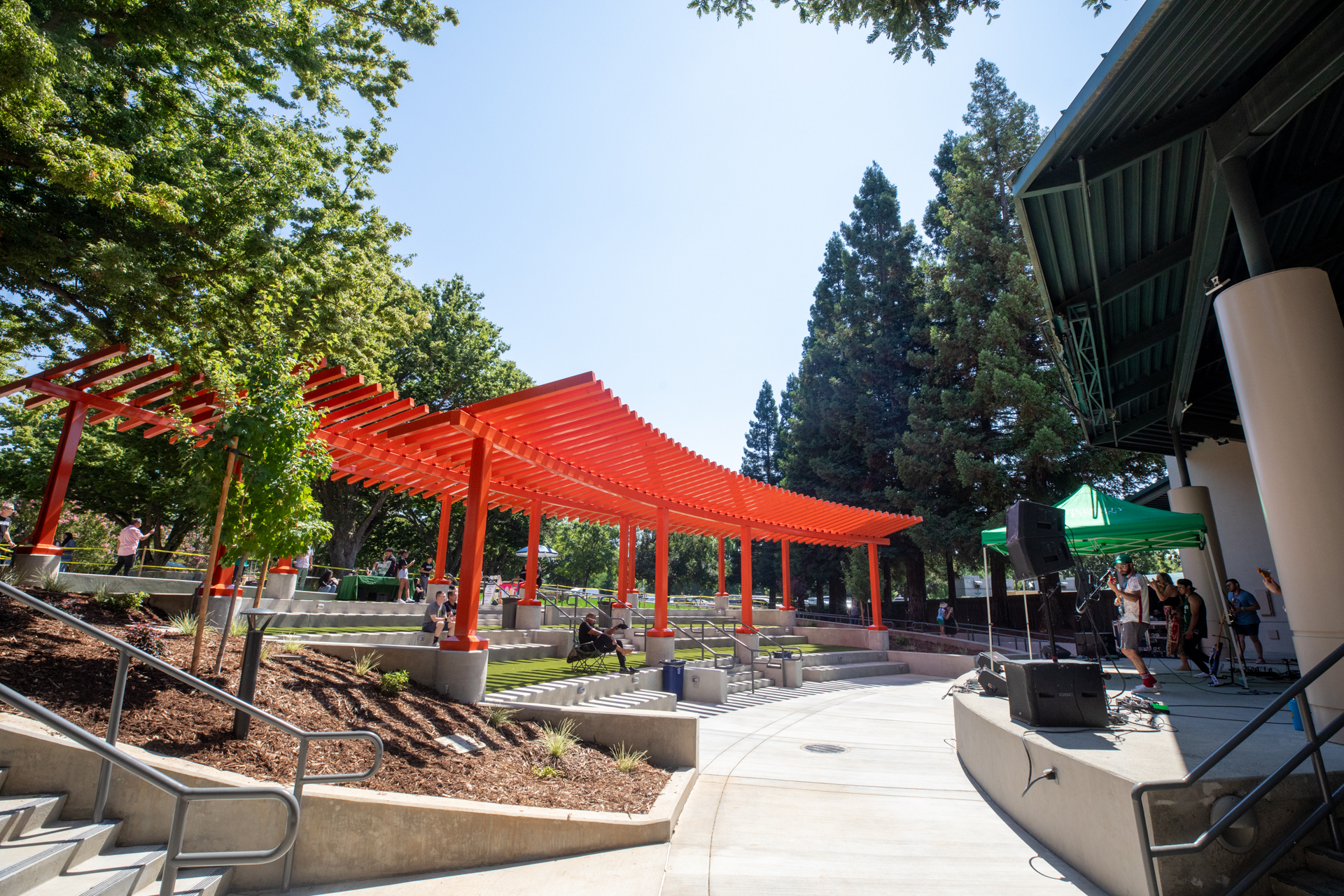 A newly renovated stage in Serna Plaza features tiered seating and shade for events.