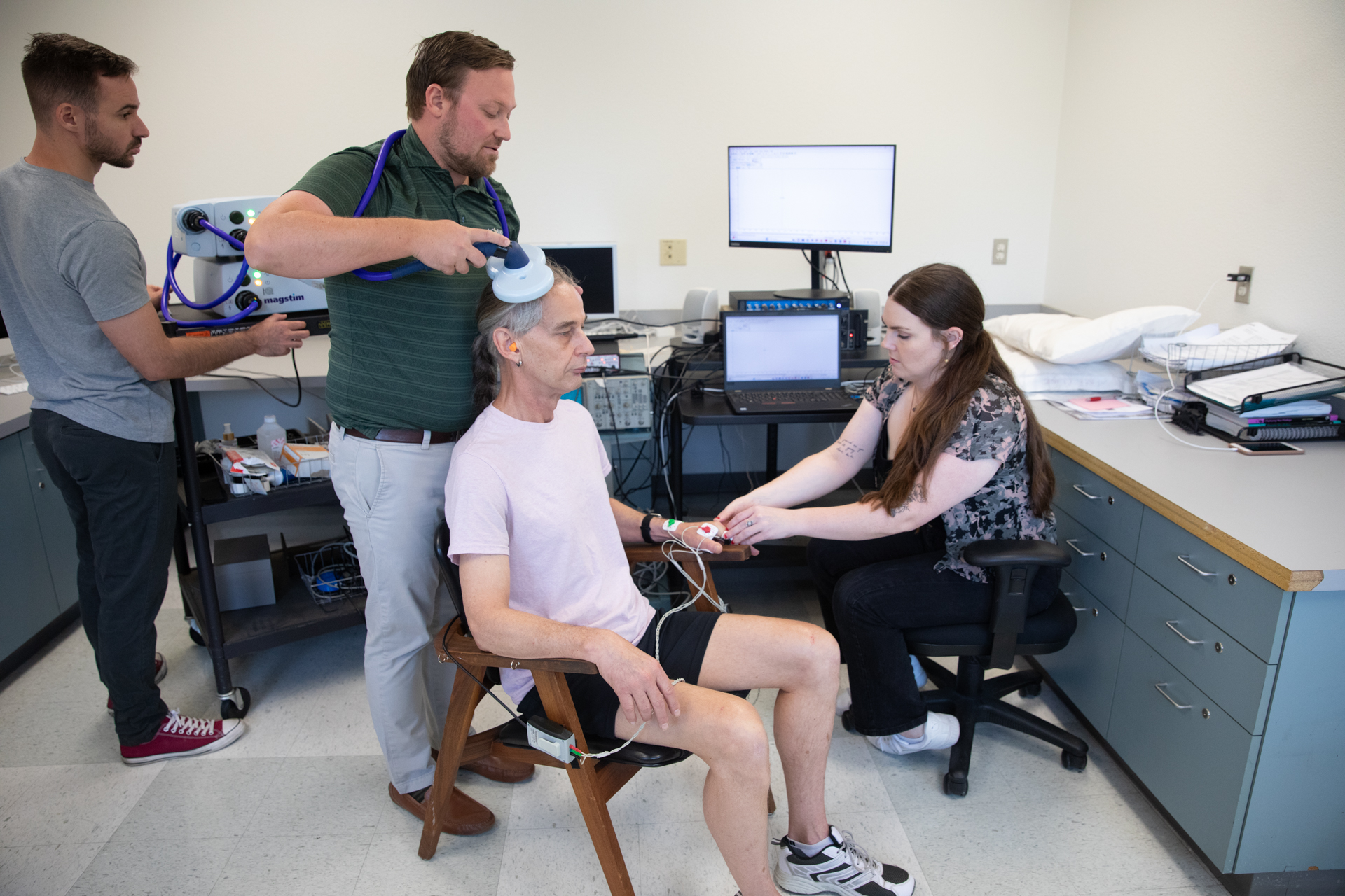 A Parkinson's patient undergoes research-related testing administered by Sac State students.