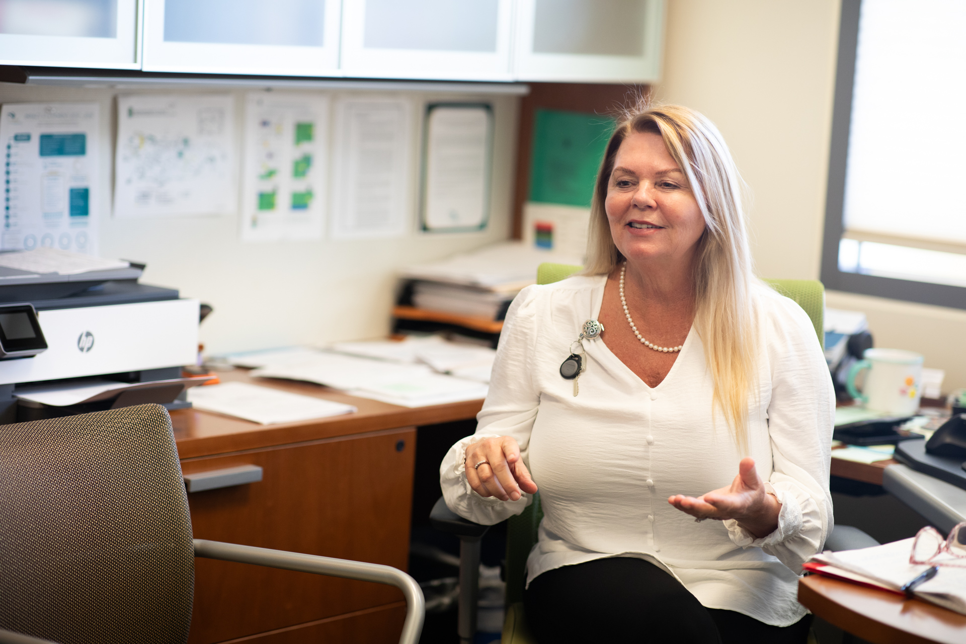 Jeanne Harris Van Dahlen, new student health director, explains her vision while sitting at her desk in her campus office.