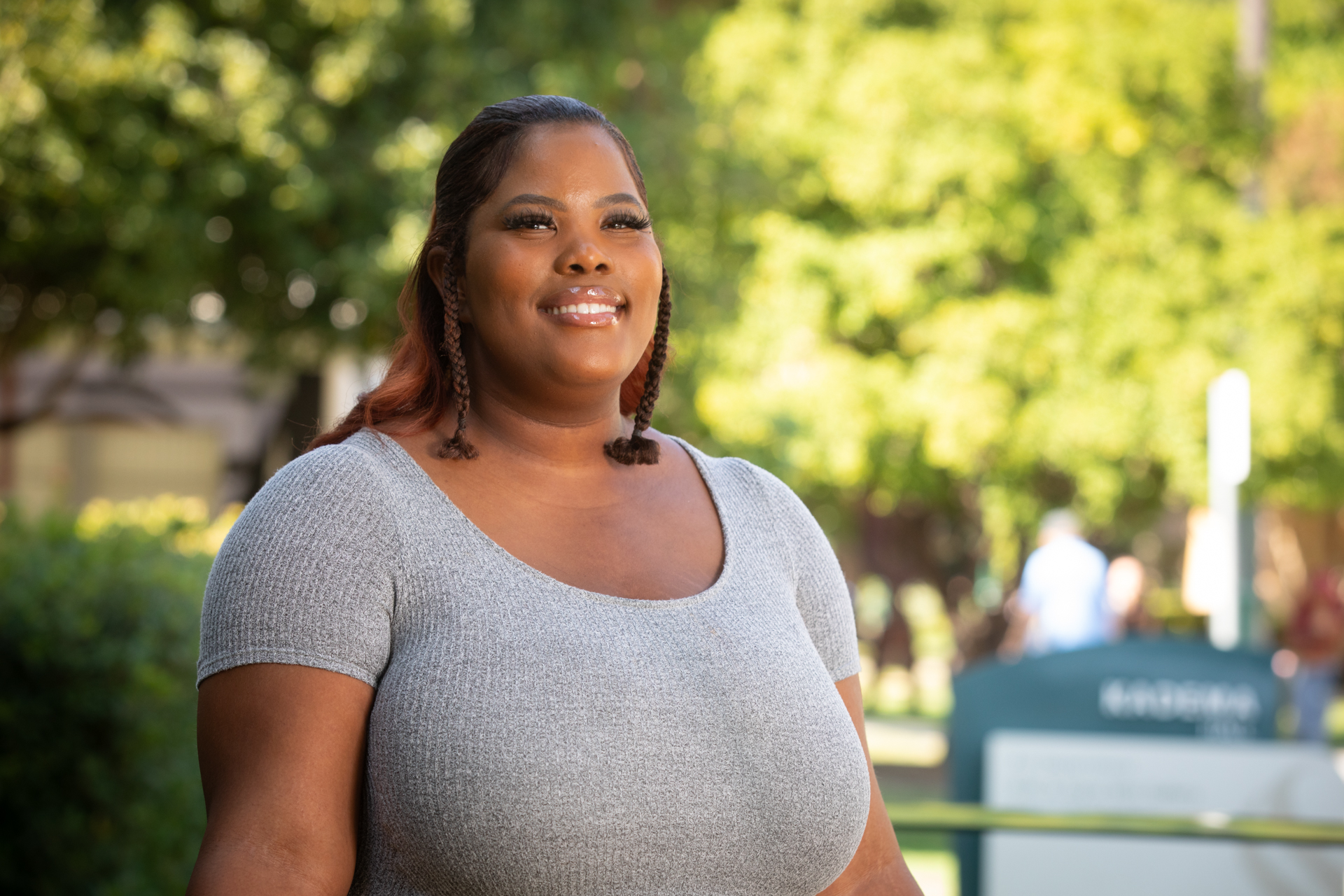 Sac State student Essence Bacon poses near a campus academic building.