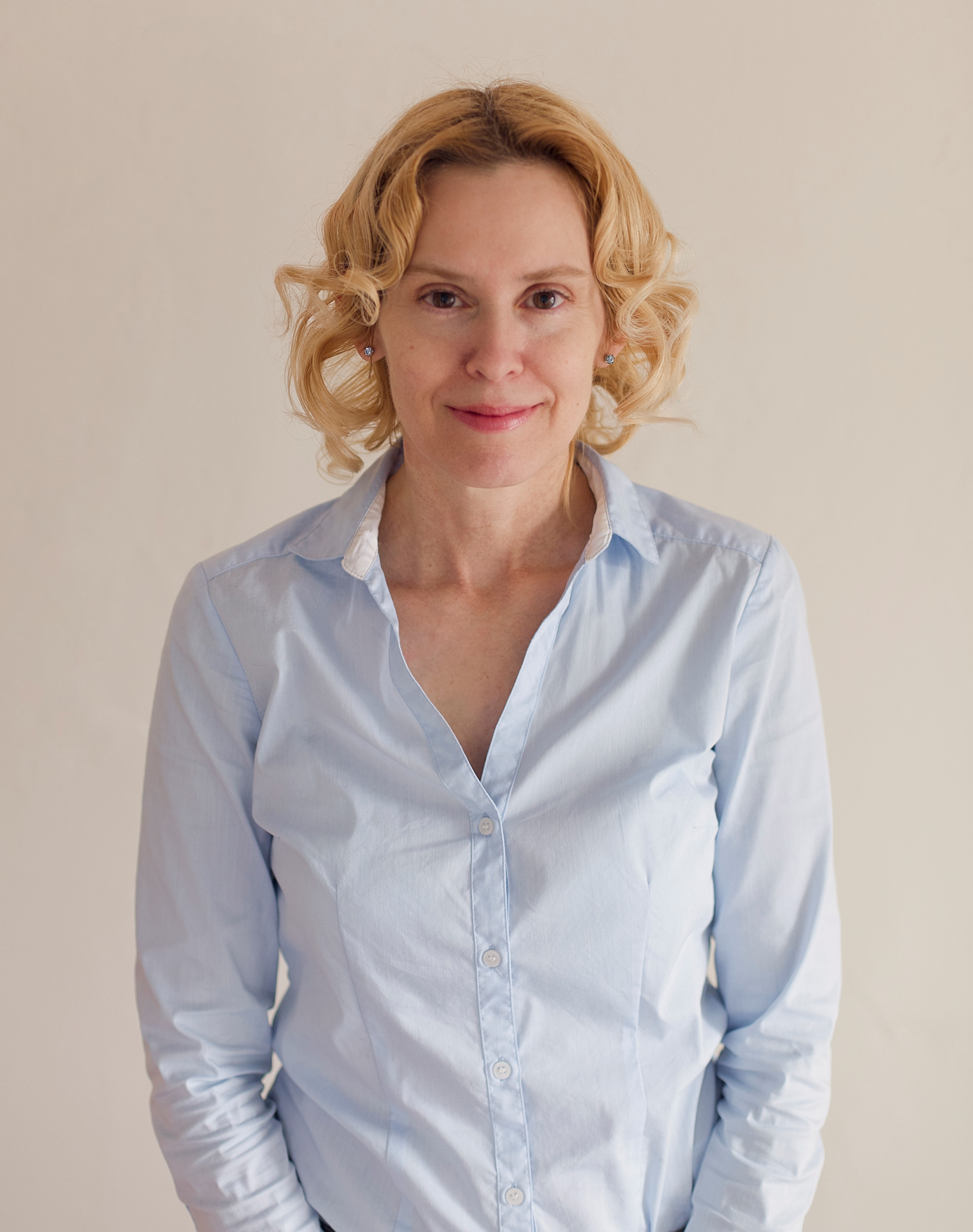 Donna Knifong wearing a blue shirt on white background.