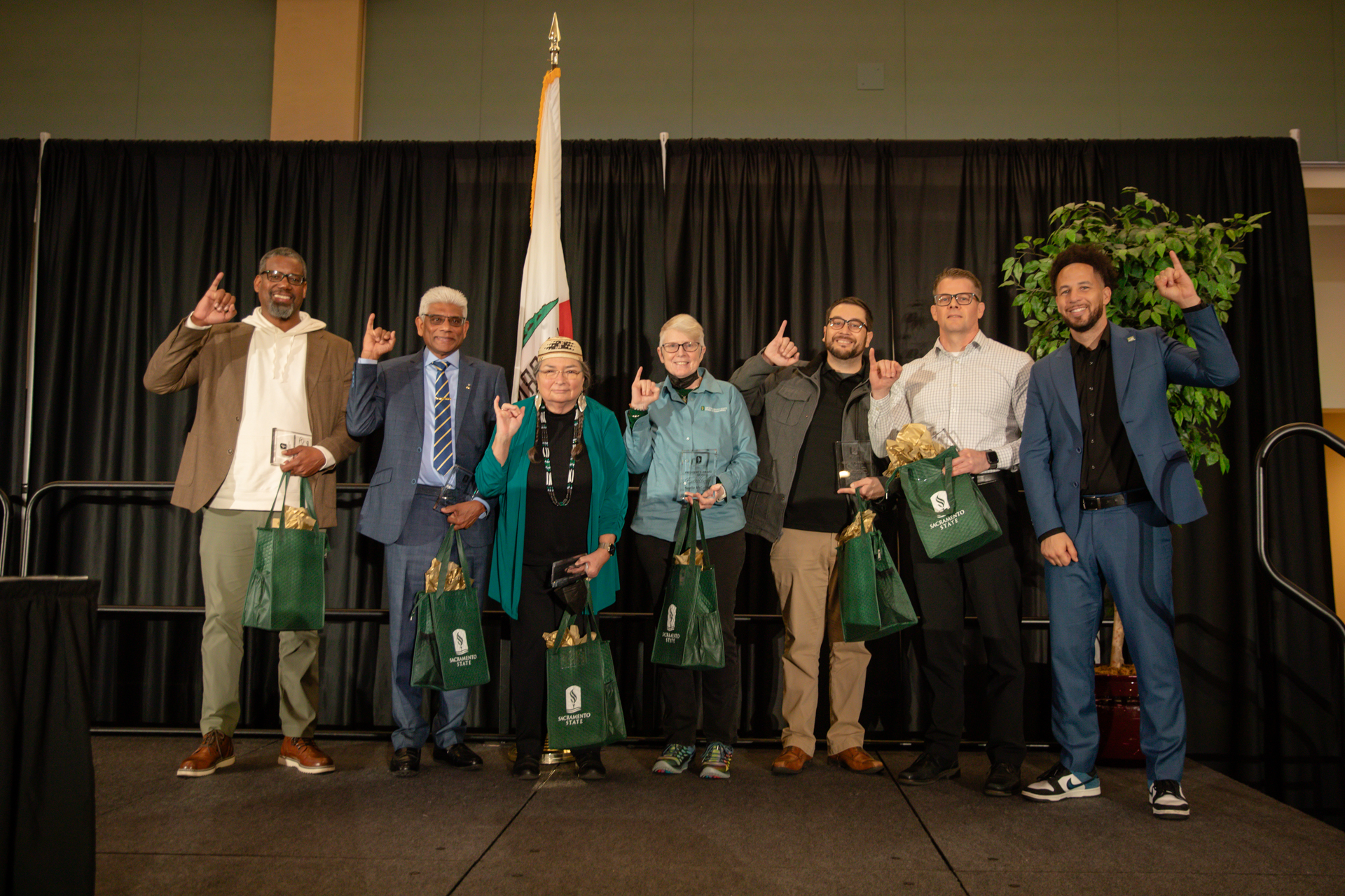 Members of the Sac State faculty pose on stage with Stingers Up during the Fall Address.