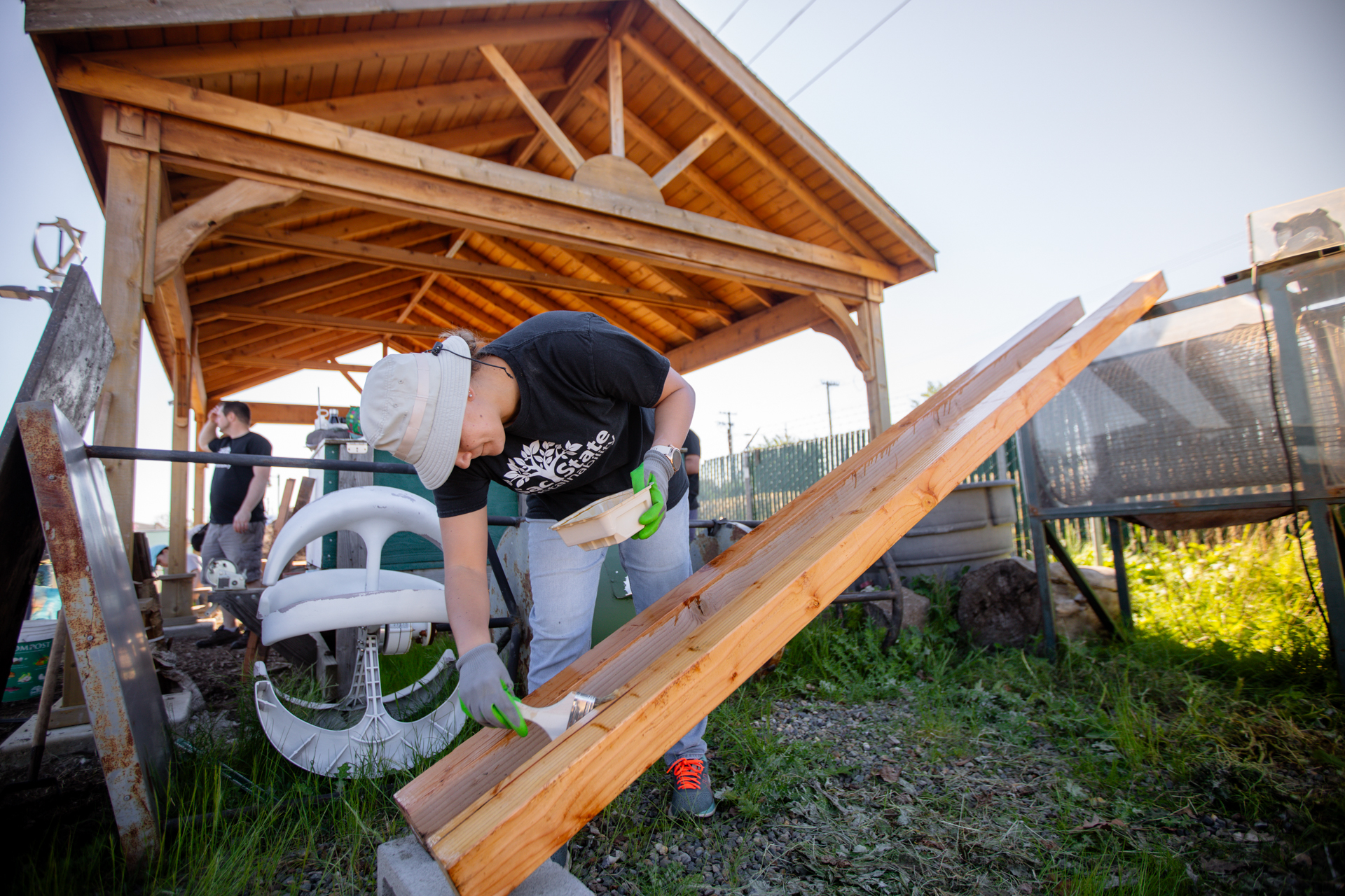 An Alternate Spring Break volunteer works on crafting a bench.