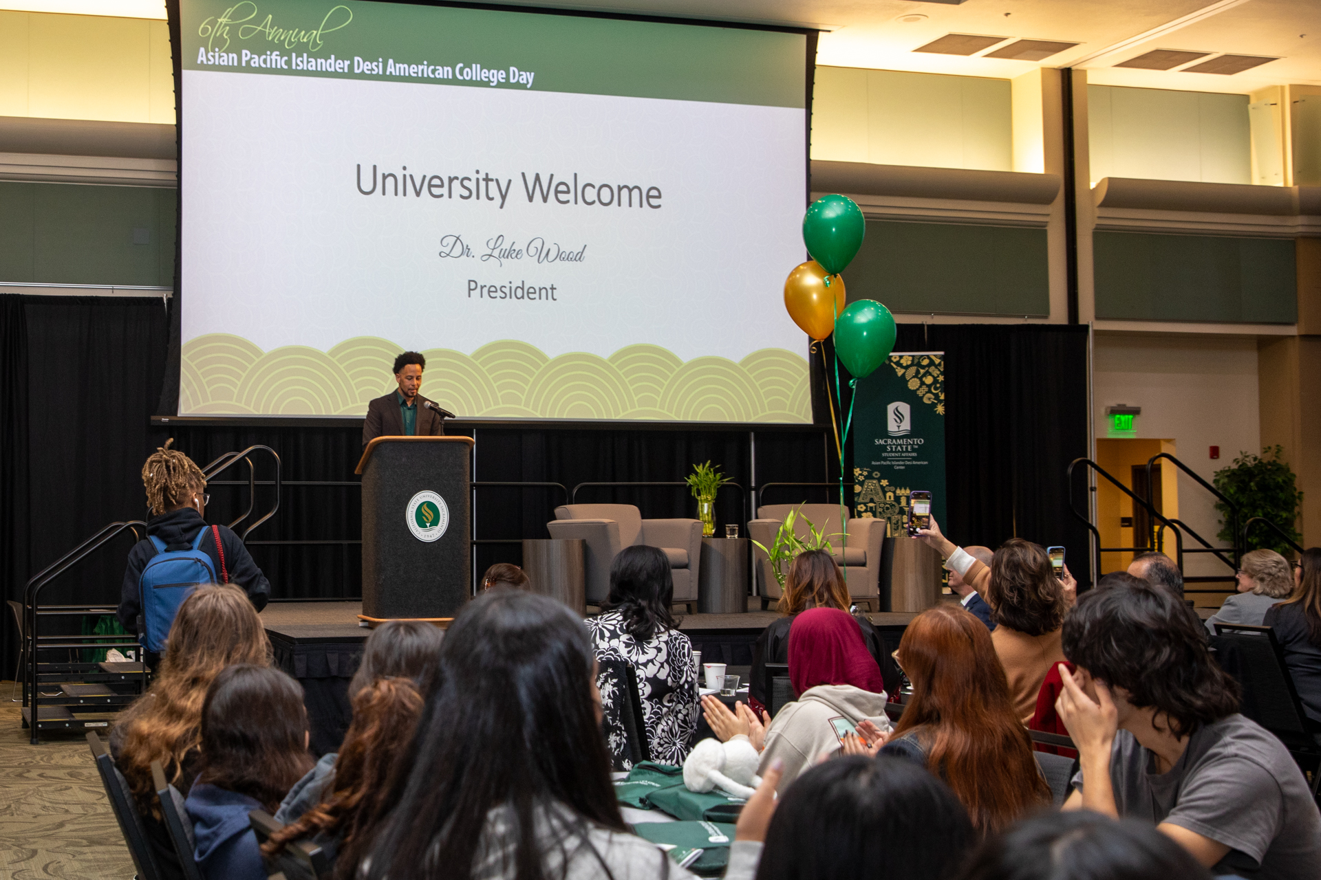 President Luke Wood on a stage, speaking to APIDA College Day attendees.