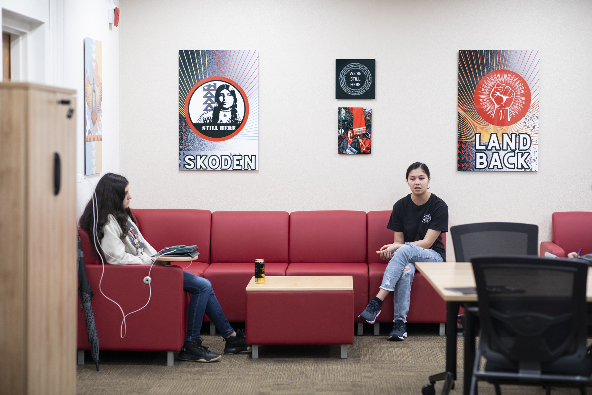 Two students sitting on a couch inside the Esak'tima' Center.