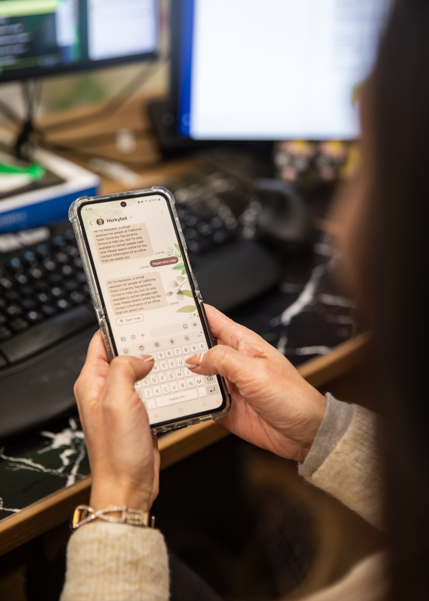 A Sac State staff member shows how Herkybot text messages work.