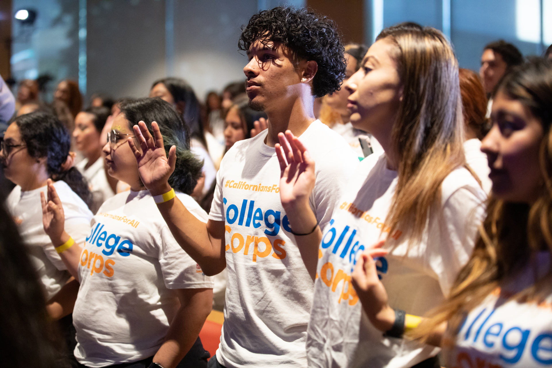 Members of College Corps attend an event in their branded T-shirts.