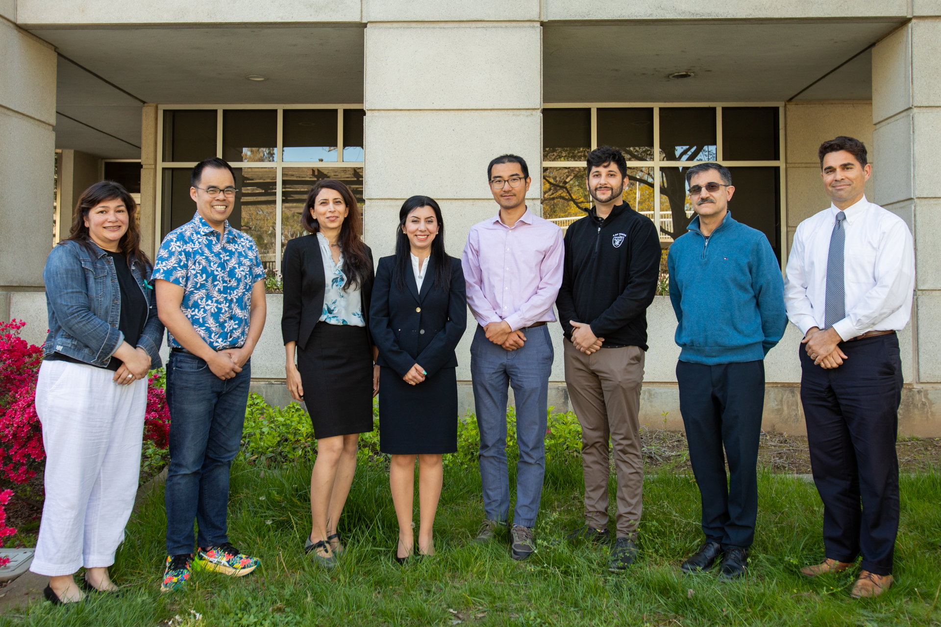 Members of the ECS diversity committee, Inclusive Excellence office and ECS administration pose outside Riverside Hall.