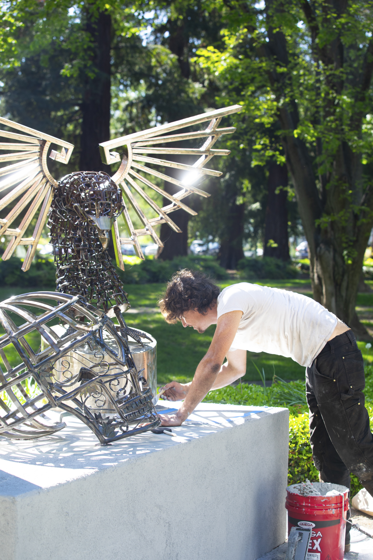 Chris Duffy woks on the "In God We Trust" sculpture installation.