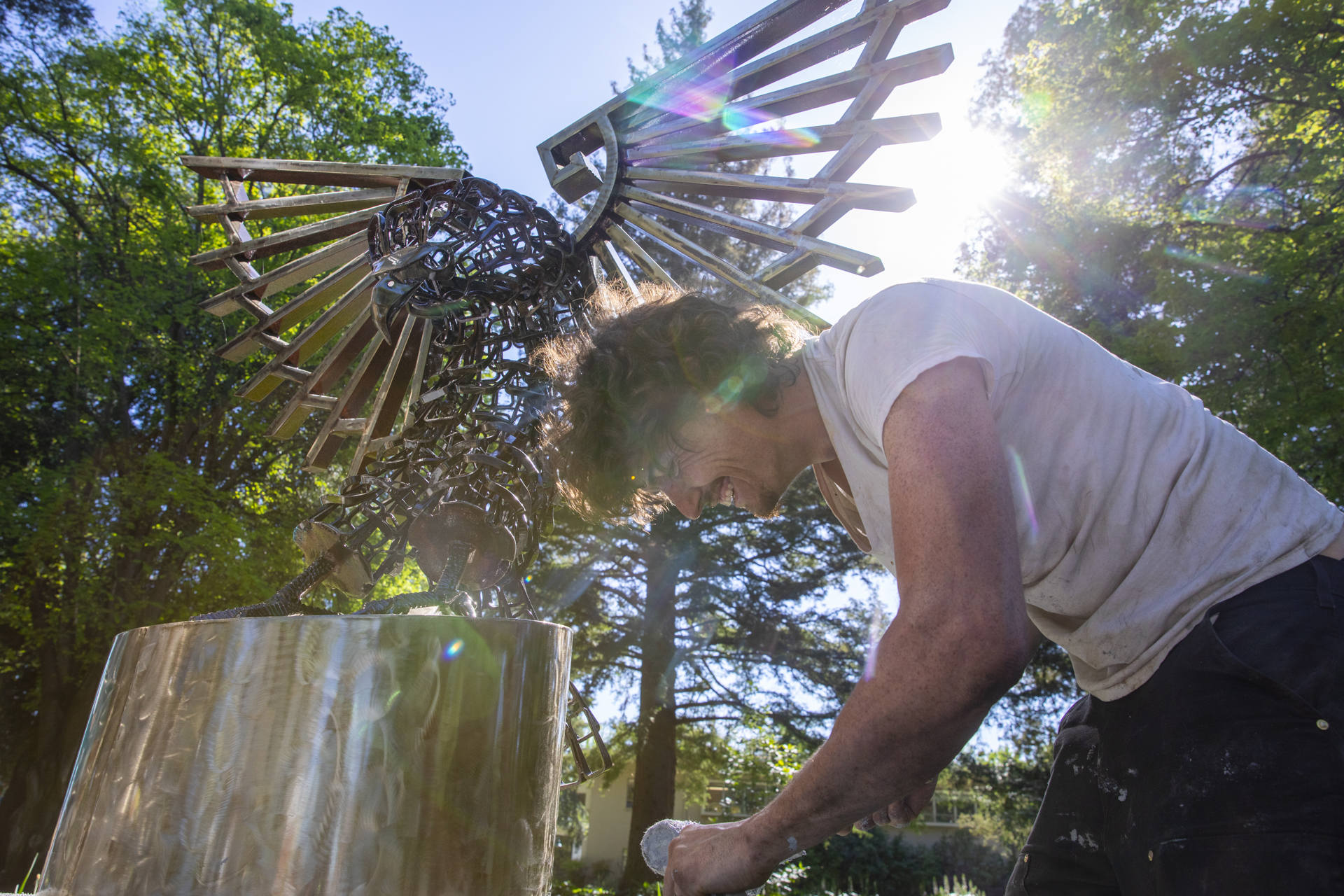 The sun pokes through Sac State's new sculpture installation "In God We Trust".