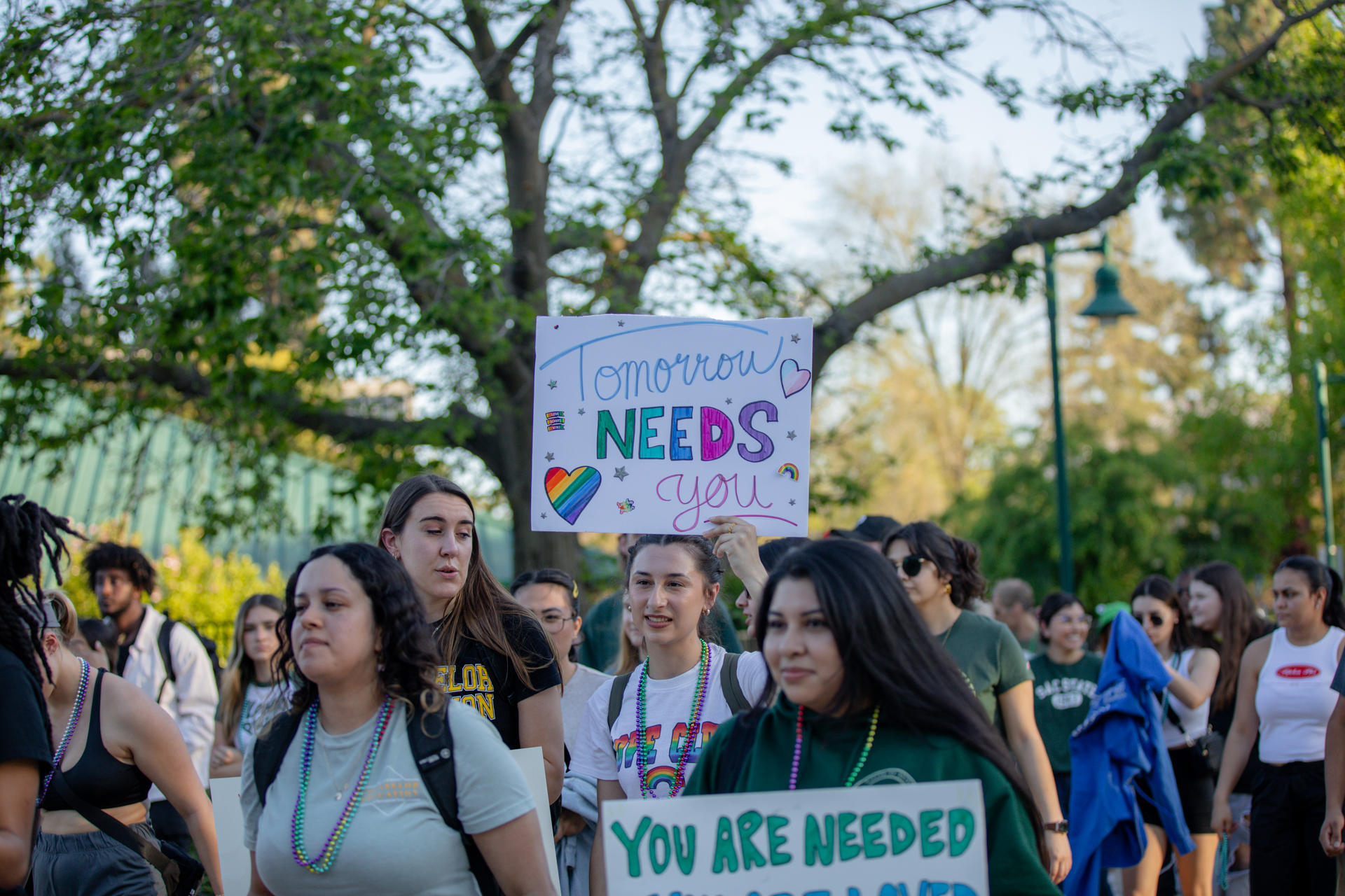 Out of the Darkness campus walk held up signs in support of mental health and suicide prevention.