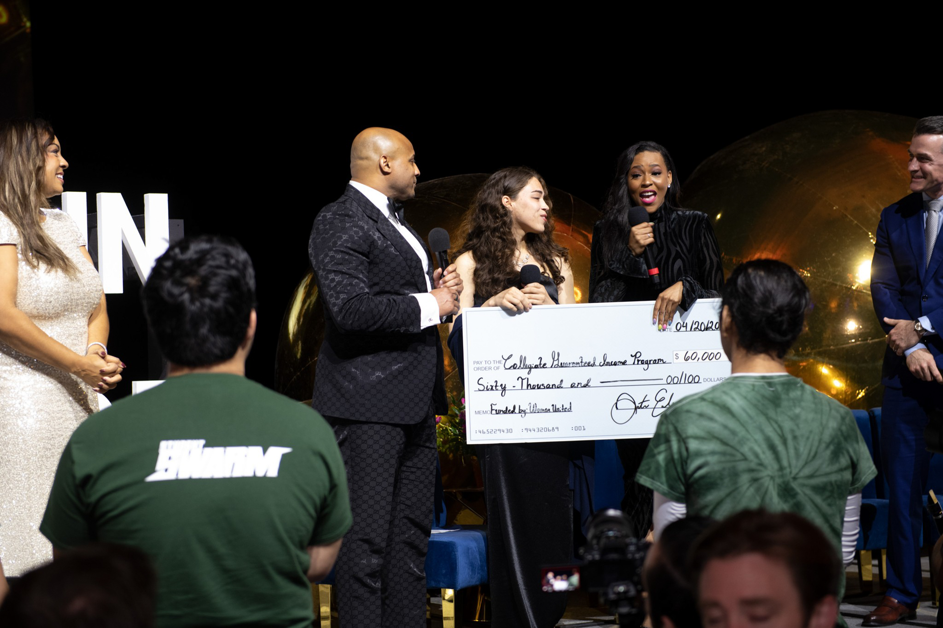 A check is presented to Guardian Scholars students.