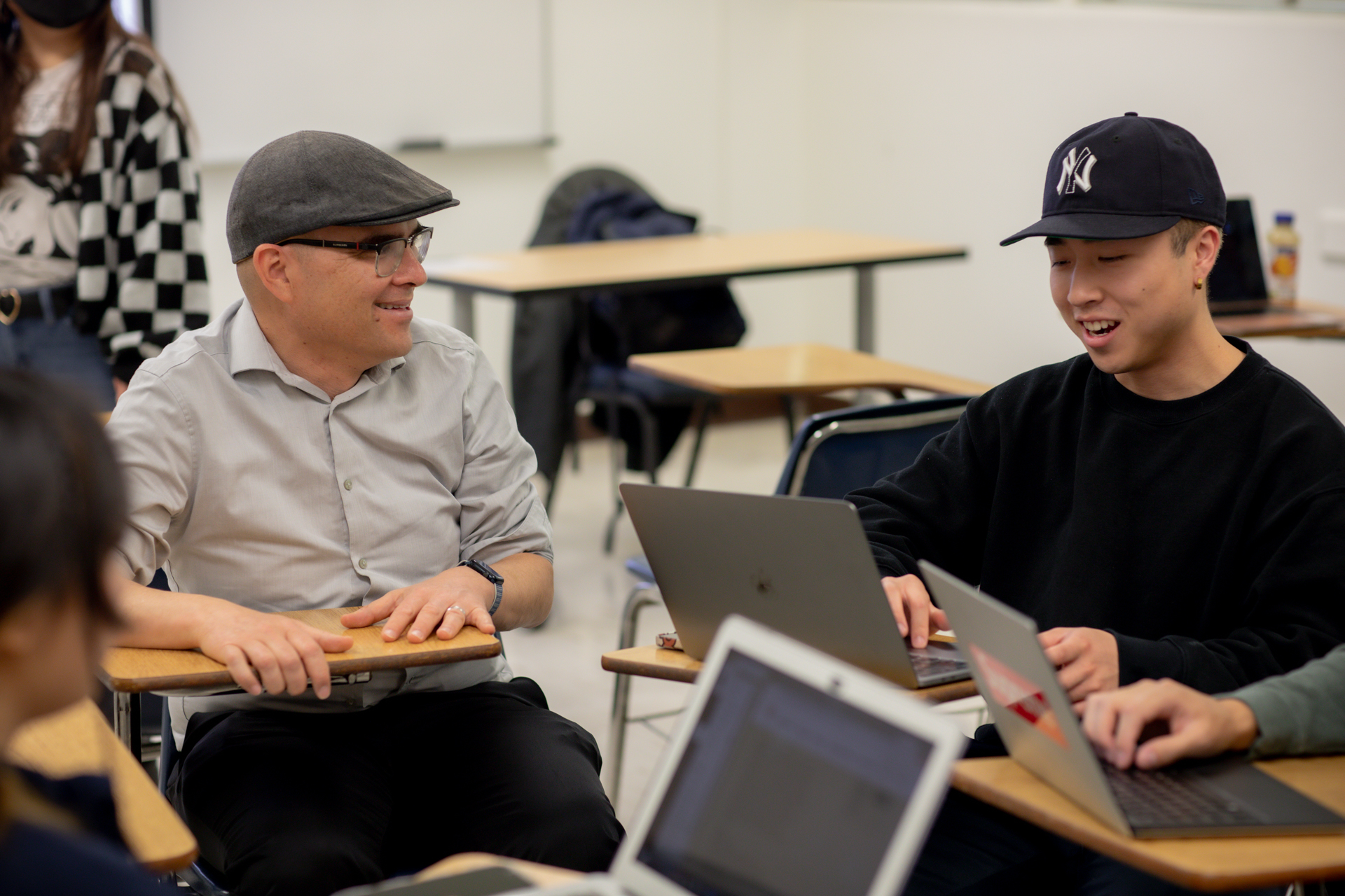 A student and a professor discuss a film project in class at Sac State.