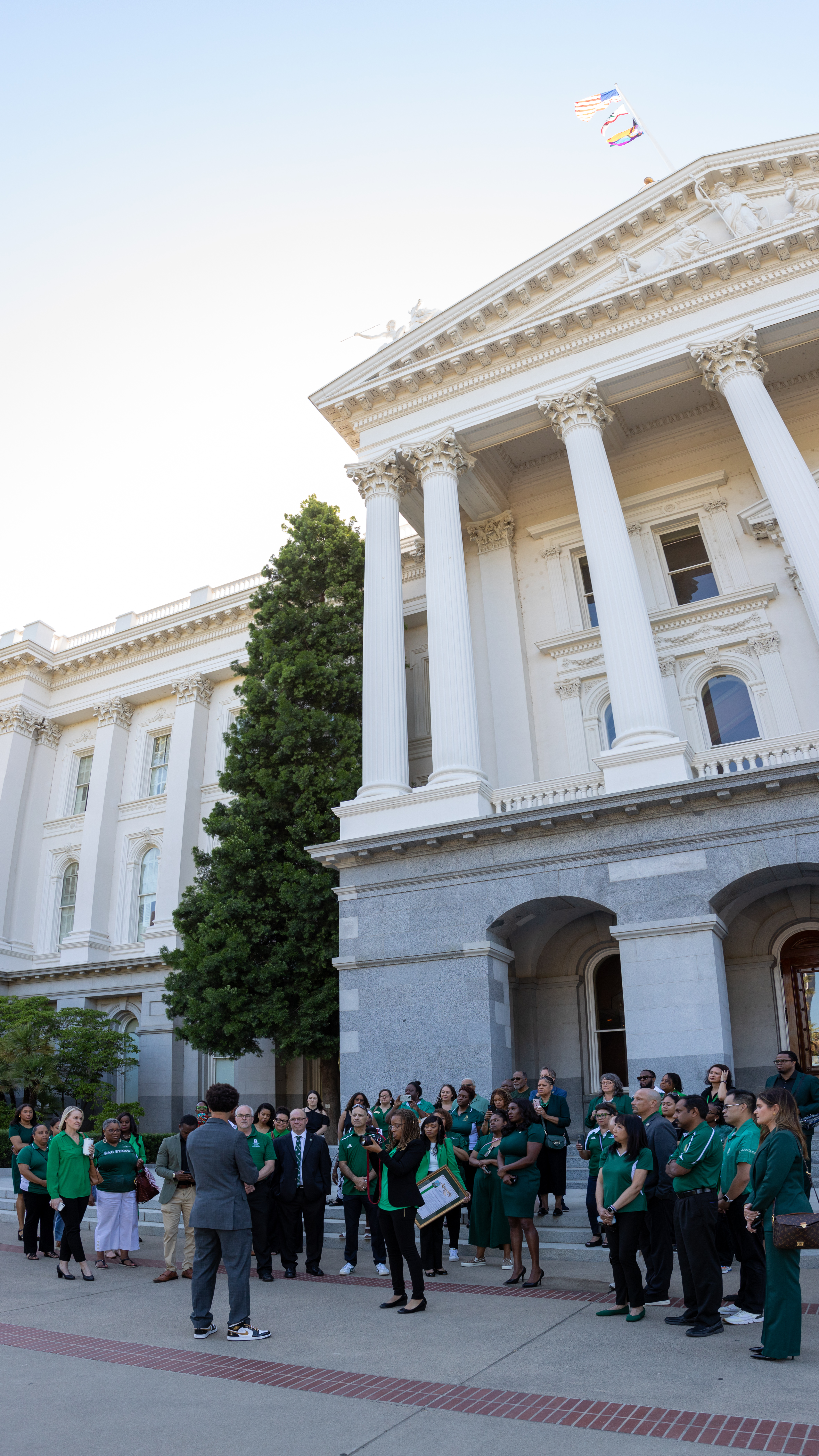 Members of campus community meet outside state Capitol.