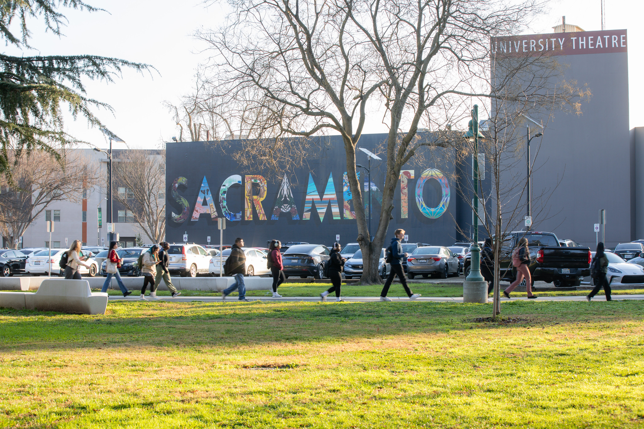 Students walk past mural at Sacramento State