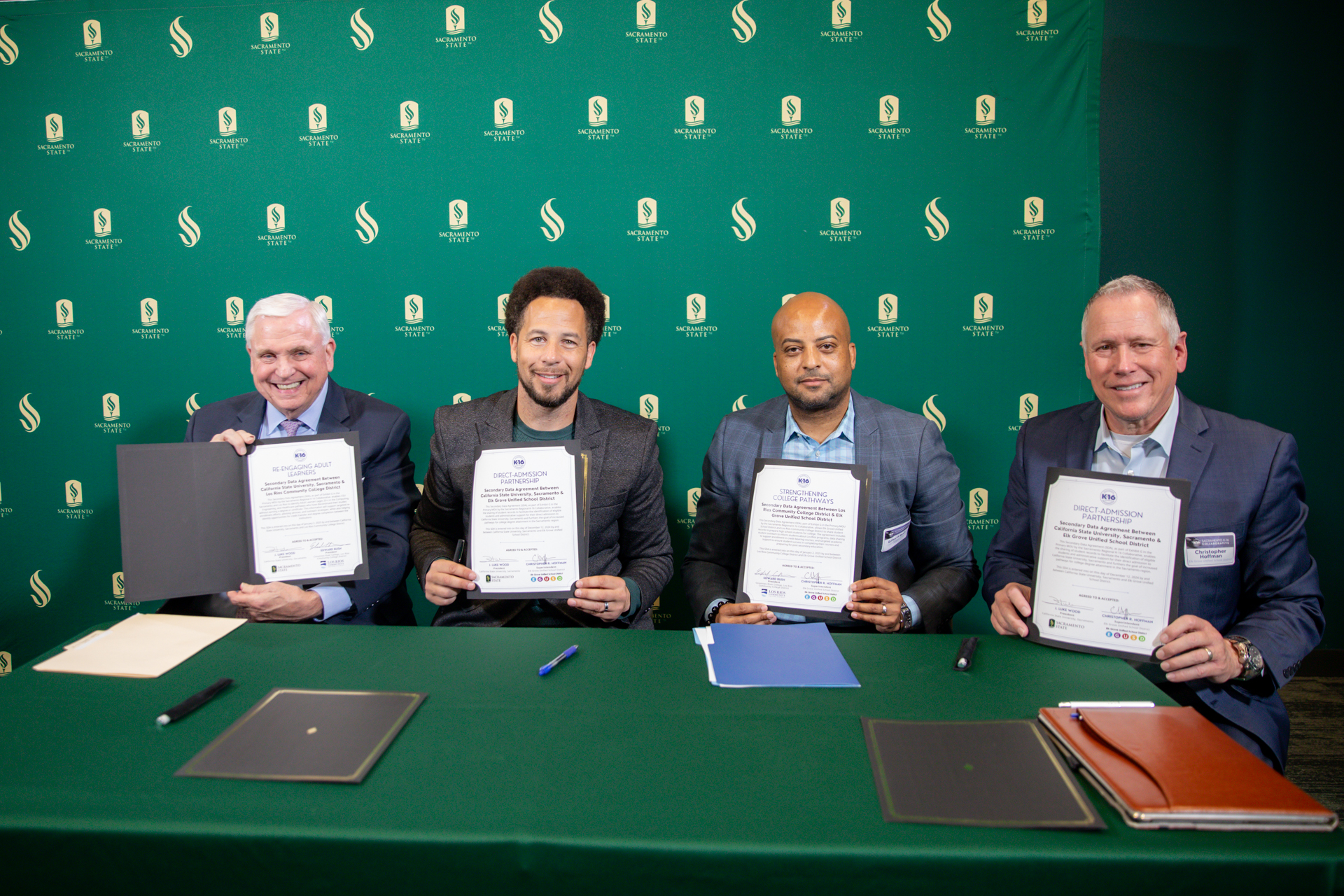 President Luke Wood and leadership from local institutions pose with signed data-sharing agreement forms.