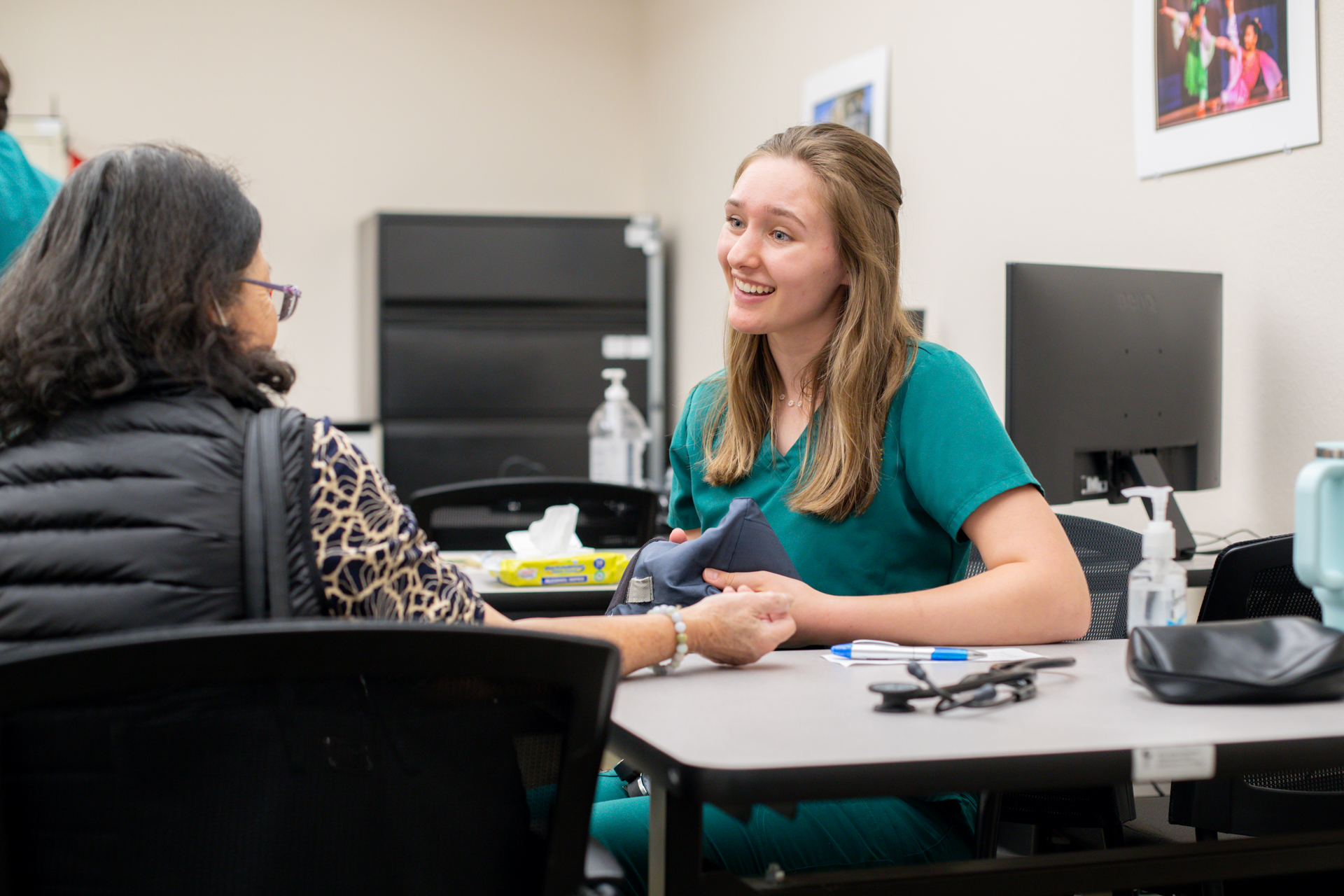 A Health Hive team member works with a patient.
