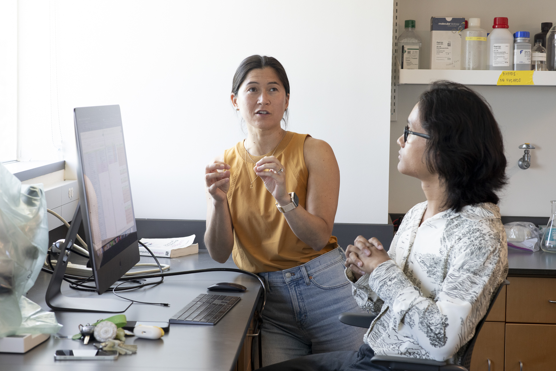 Student Kevin Salimo and Professor Lani Gleason talking in front of a computer.
