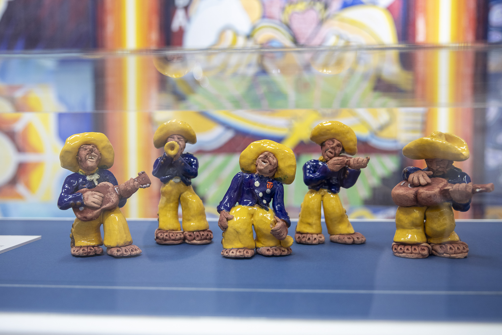 Several small ceramic figures playing musical instruments.