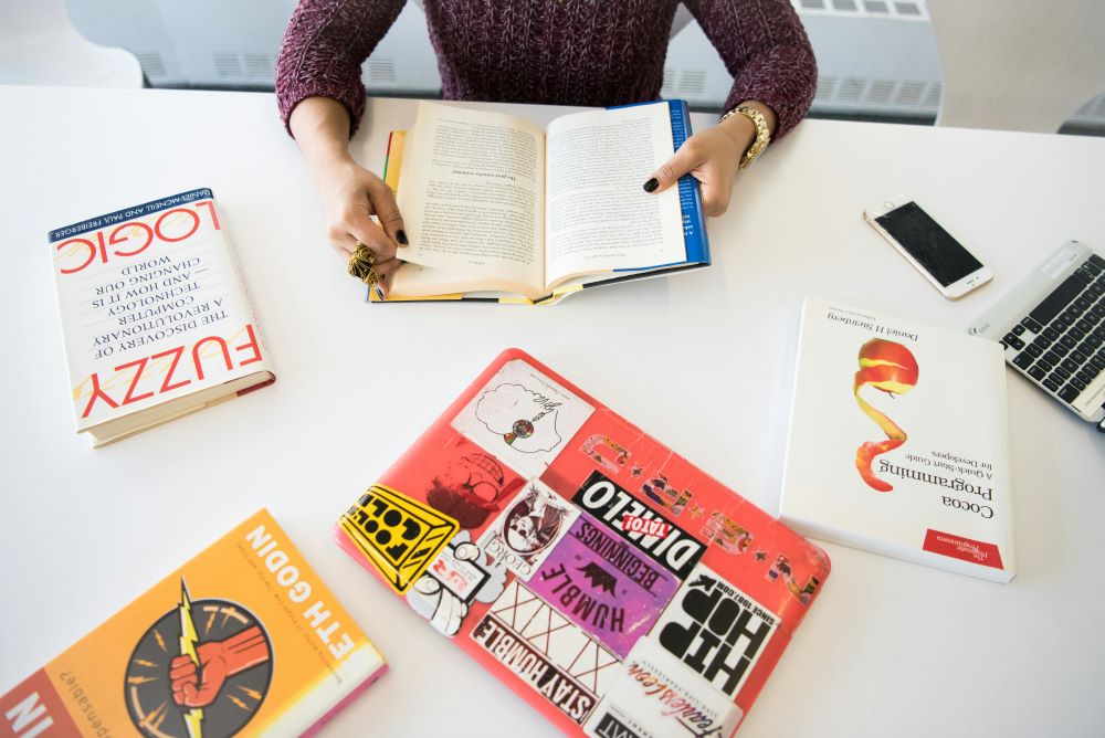 Close-up of a person focused on reading a book at a table