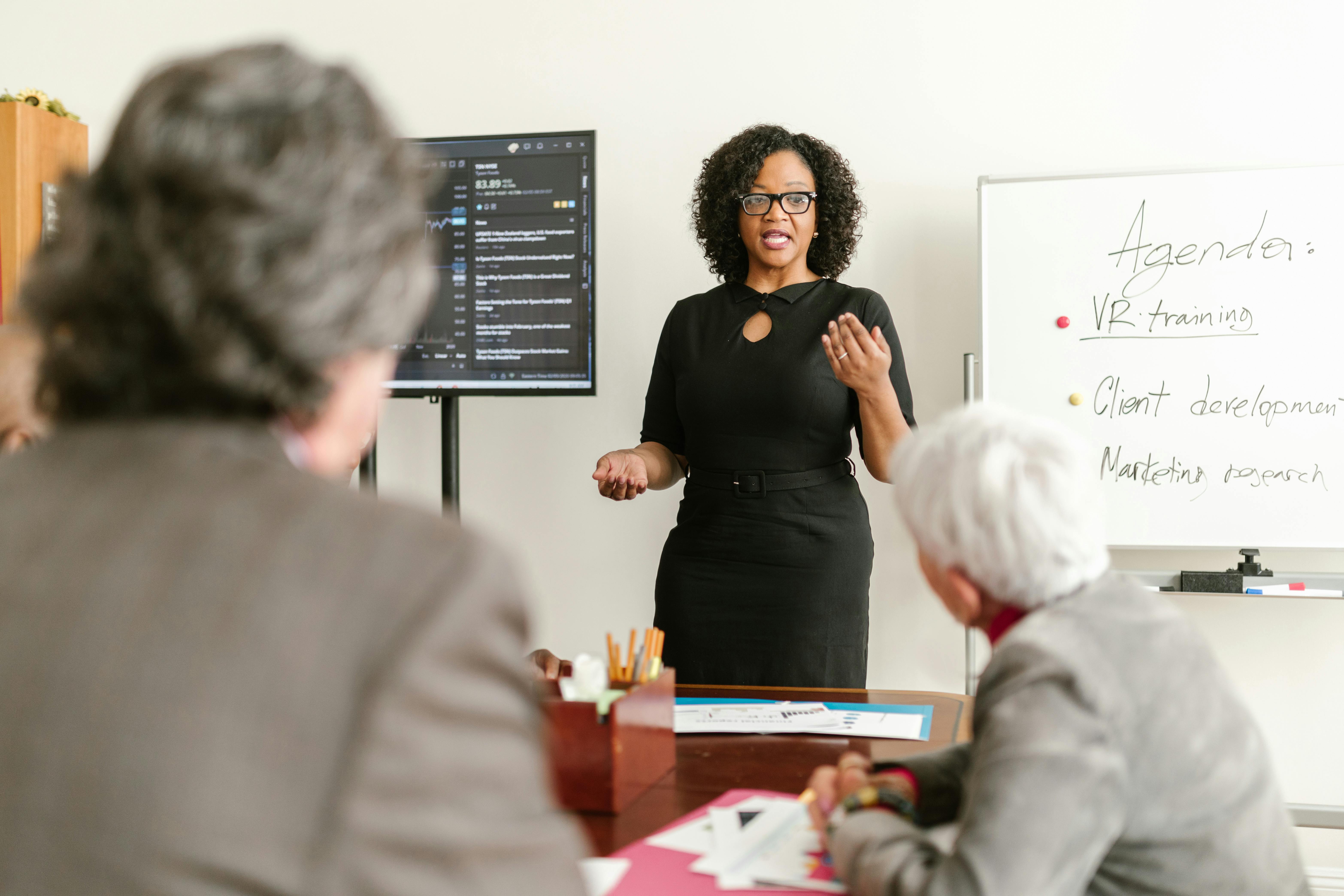 presenter speaking in front of audience in boardroom