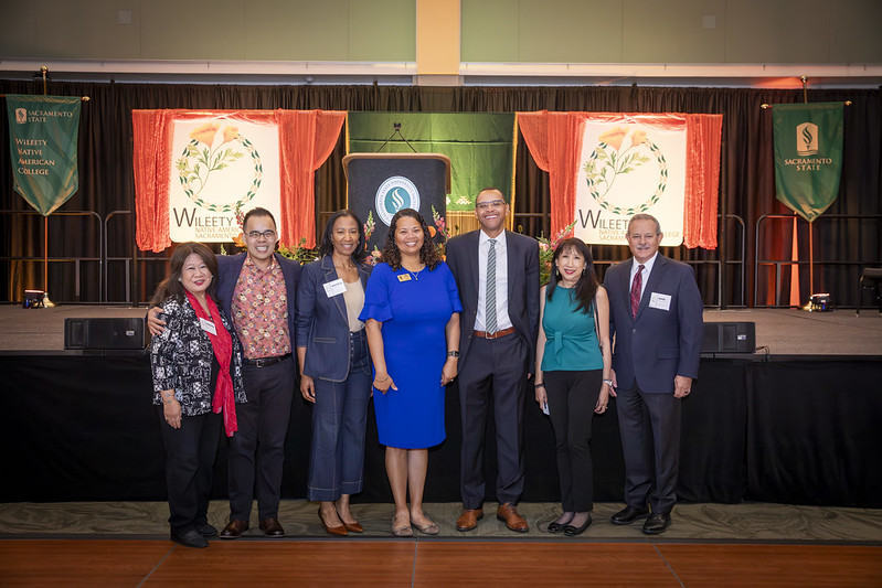 Cabinet members in front of the stage at the grand opening