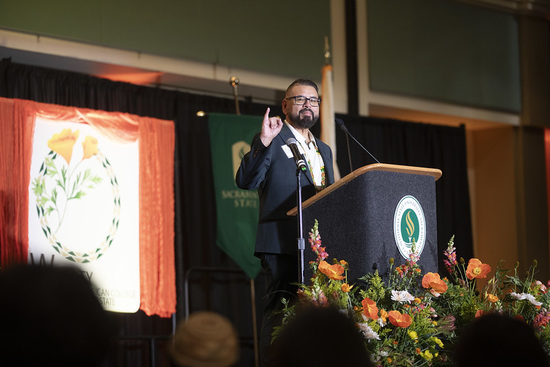 Thomas Lozano holding stingers up! while giving a speech at the grand opening