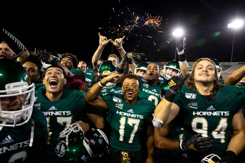 Football players celebrating at homecoming