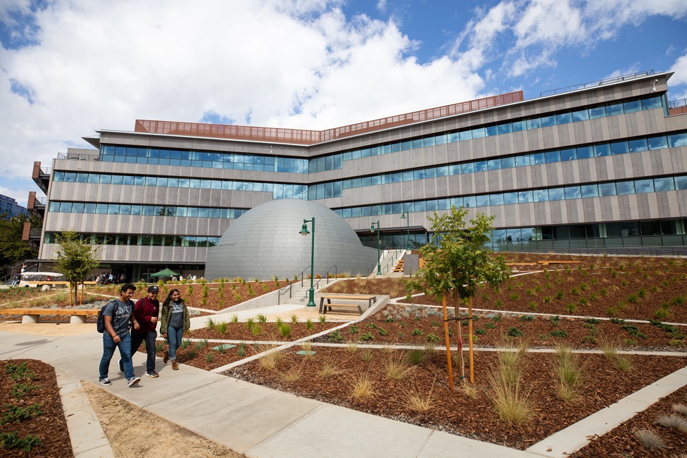 Students walking outside in front of the science building