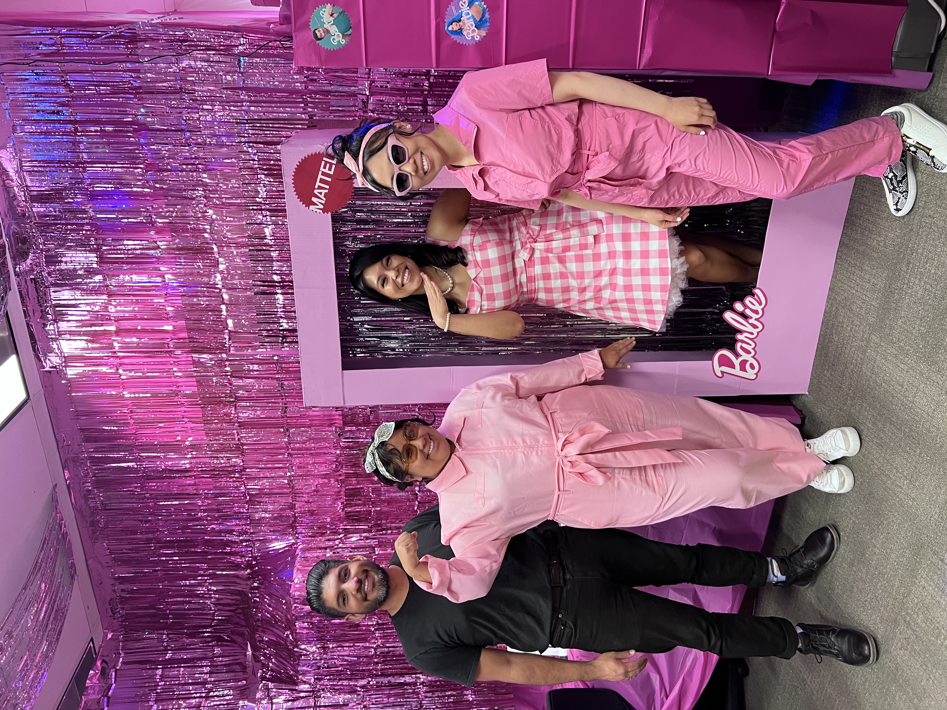 Educational Opportunity Program: Barbie Land group posing in costumes in front of office decoration including a life-size barbie box