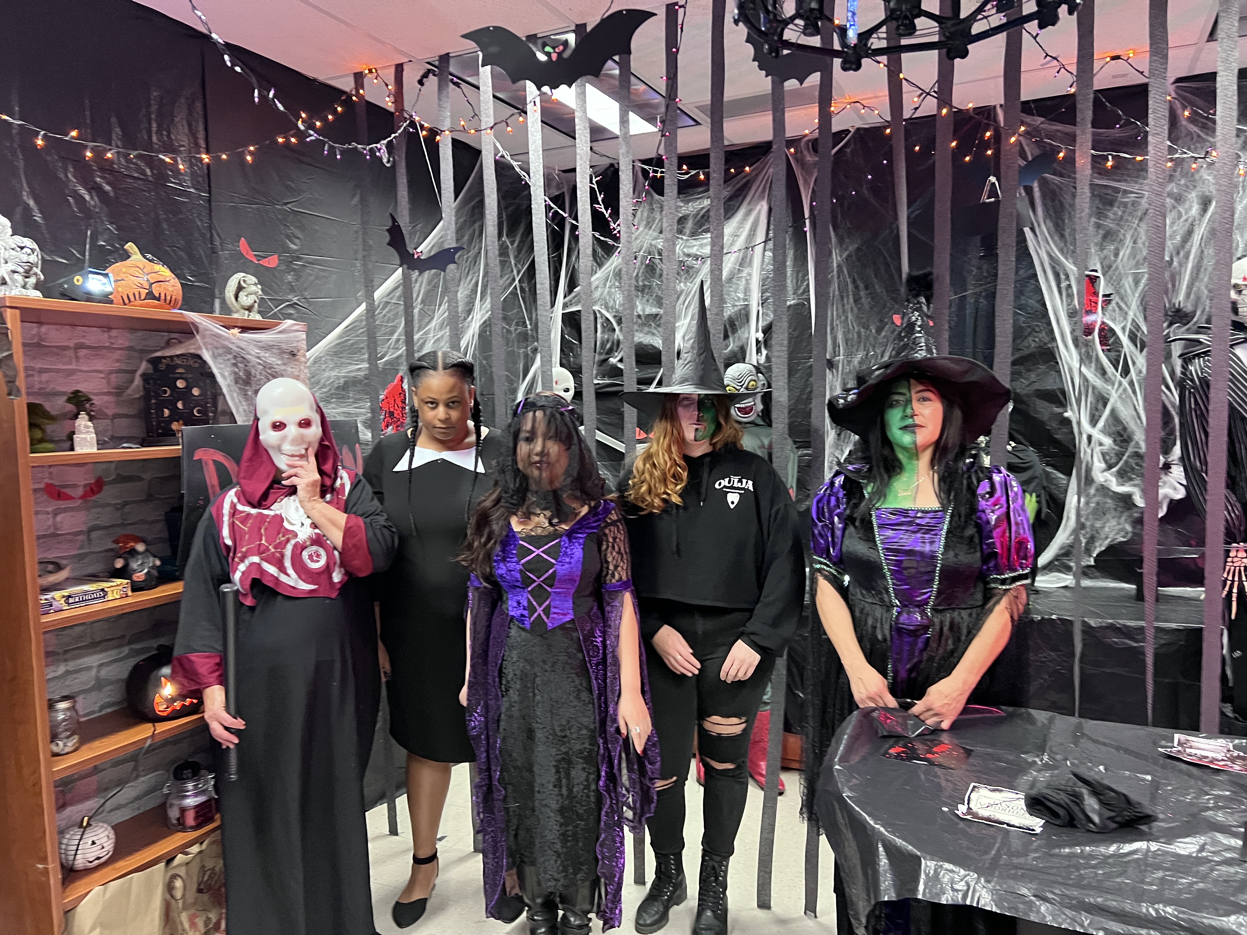 School of Social Work “Social Work Dungeon” group dressed in costumes in front of decorated scary dungeon office