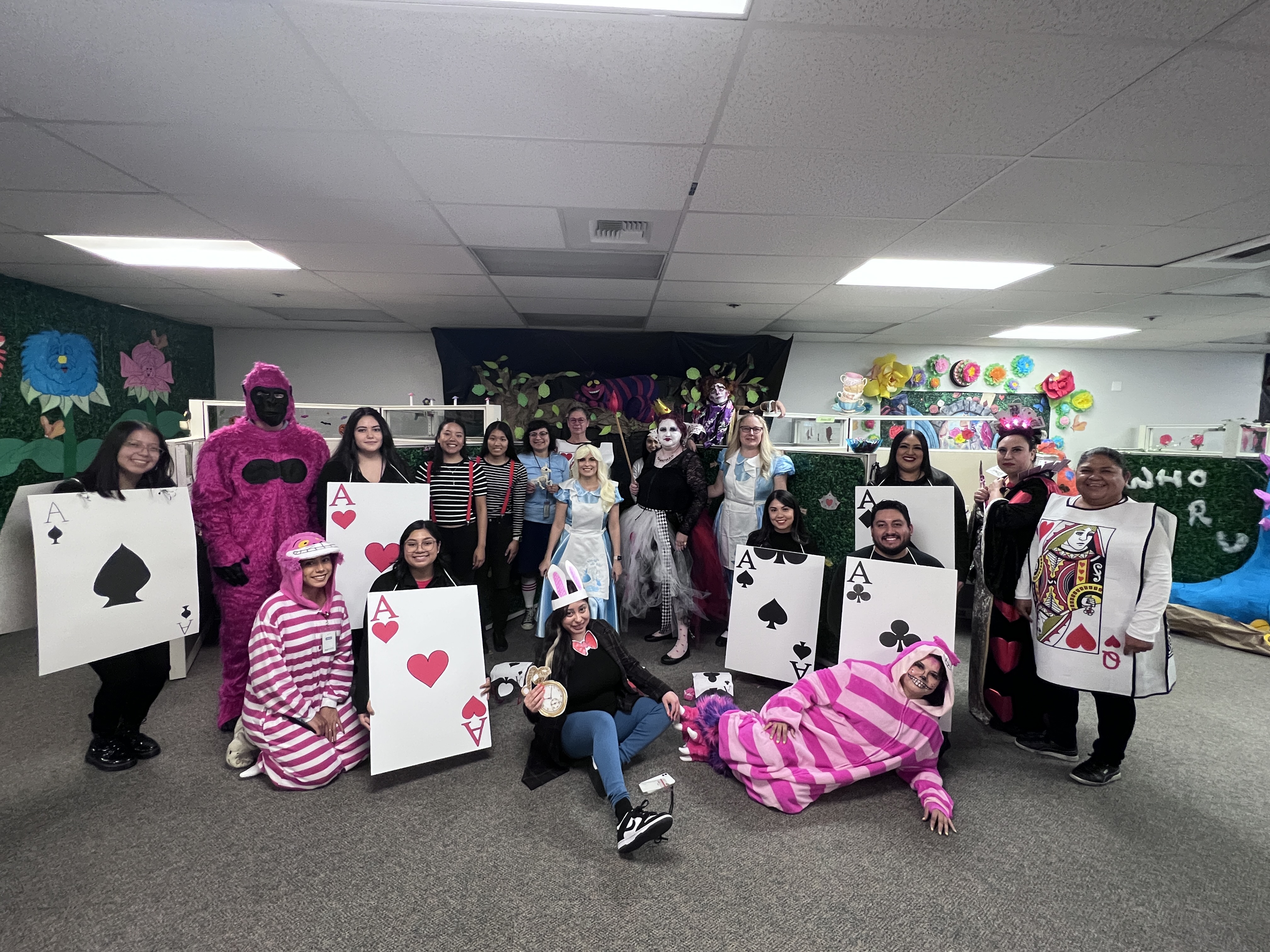 Population Research Center “Alice in Wonderland” group costumes in front of theme decorated office