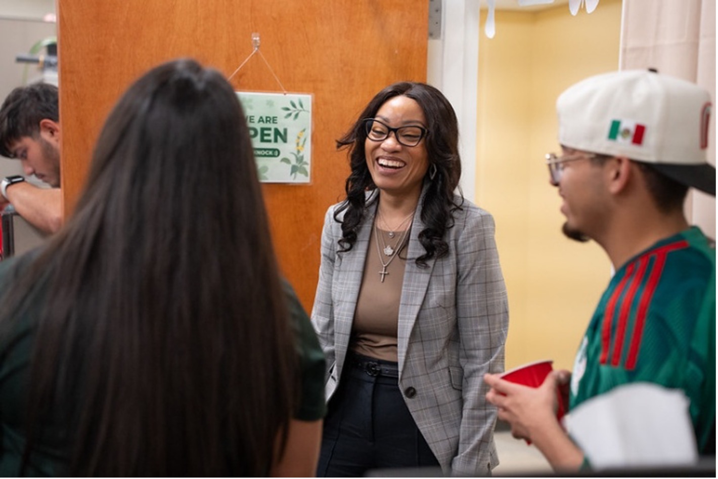 The Vice President of Student Affairs smiling with a group of students