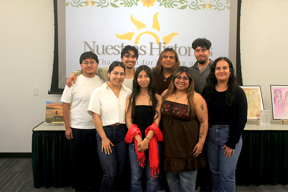 A group of students taking a photo smiling at the camera.