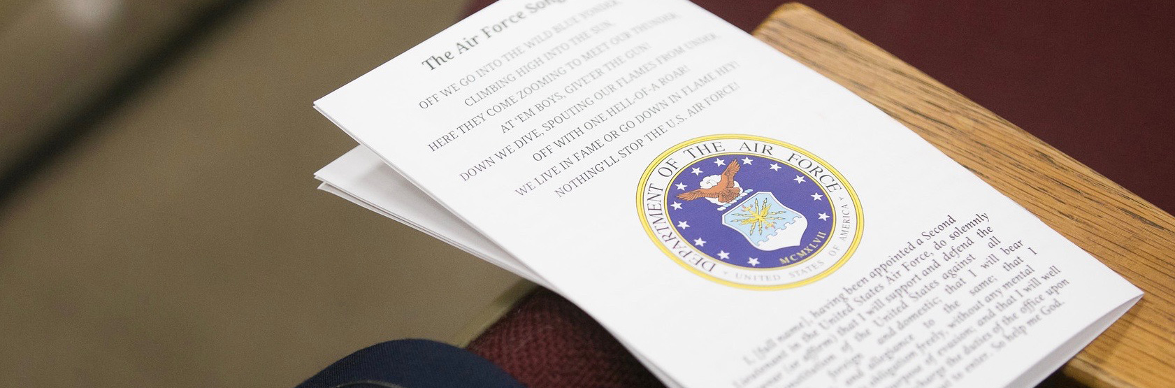 Stack of papers on desk with US Government seal