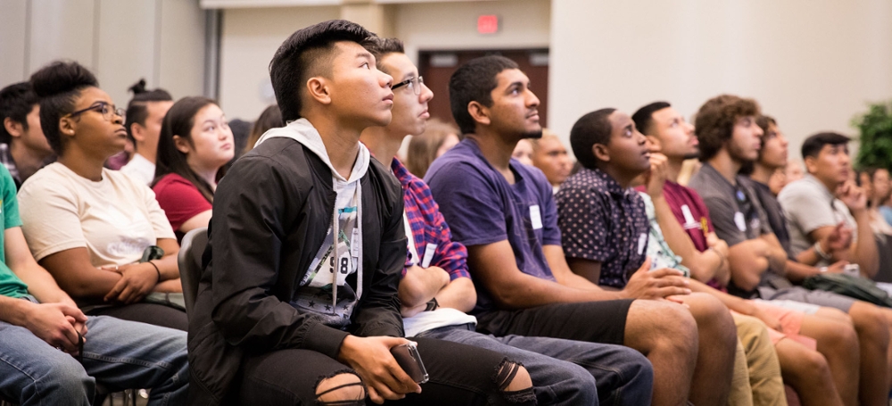 Picture of a mass of students in a meeting.
