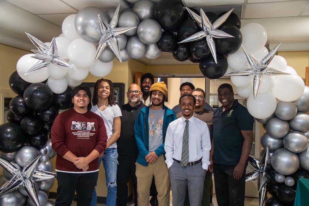 Group of male students celebrating graduation