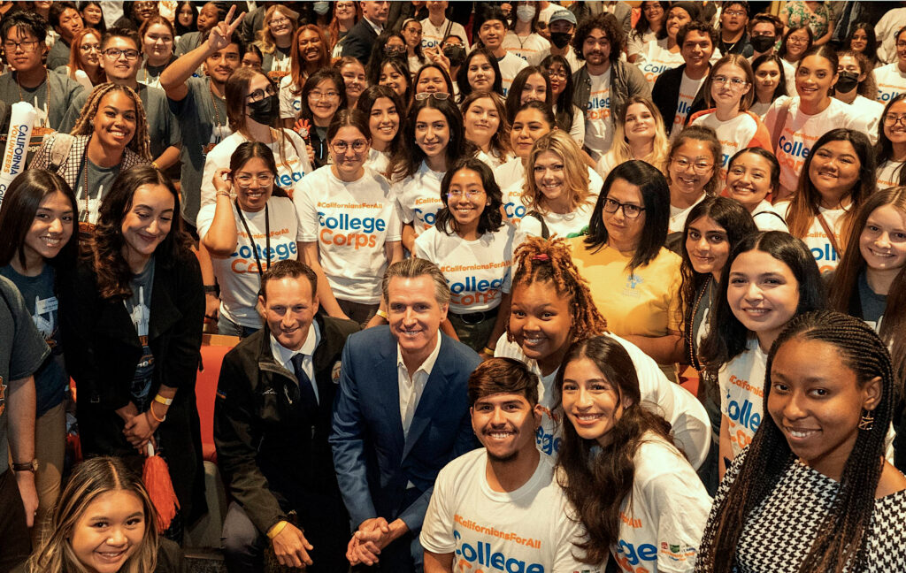 photo of a group of students posing to the camera with CA Governor Gavin Newson