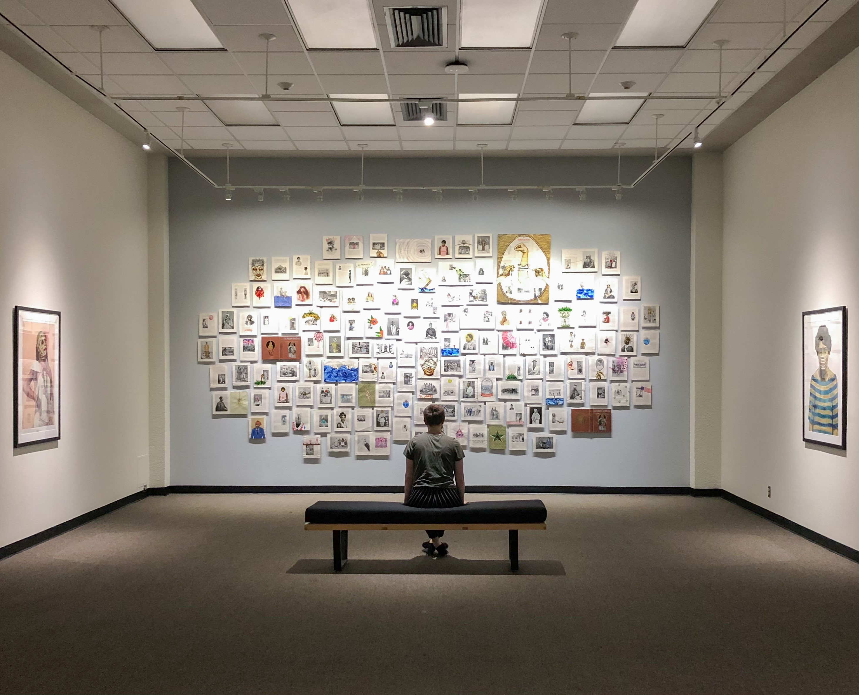 student sitting in front of Kahlon installation of book page project